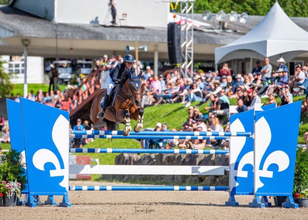 Boucherville, QC's Alexanne Thibault with Cidanos Z over the Quebec jump in the CSI2* 1.45m Grand Prix. © Tom von Kapherr Photography