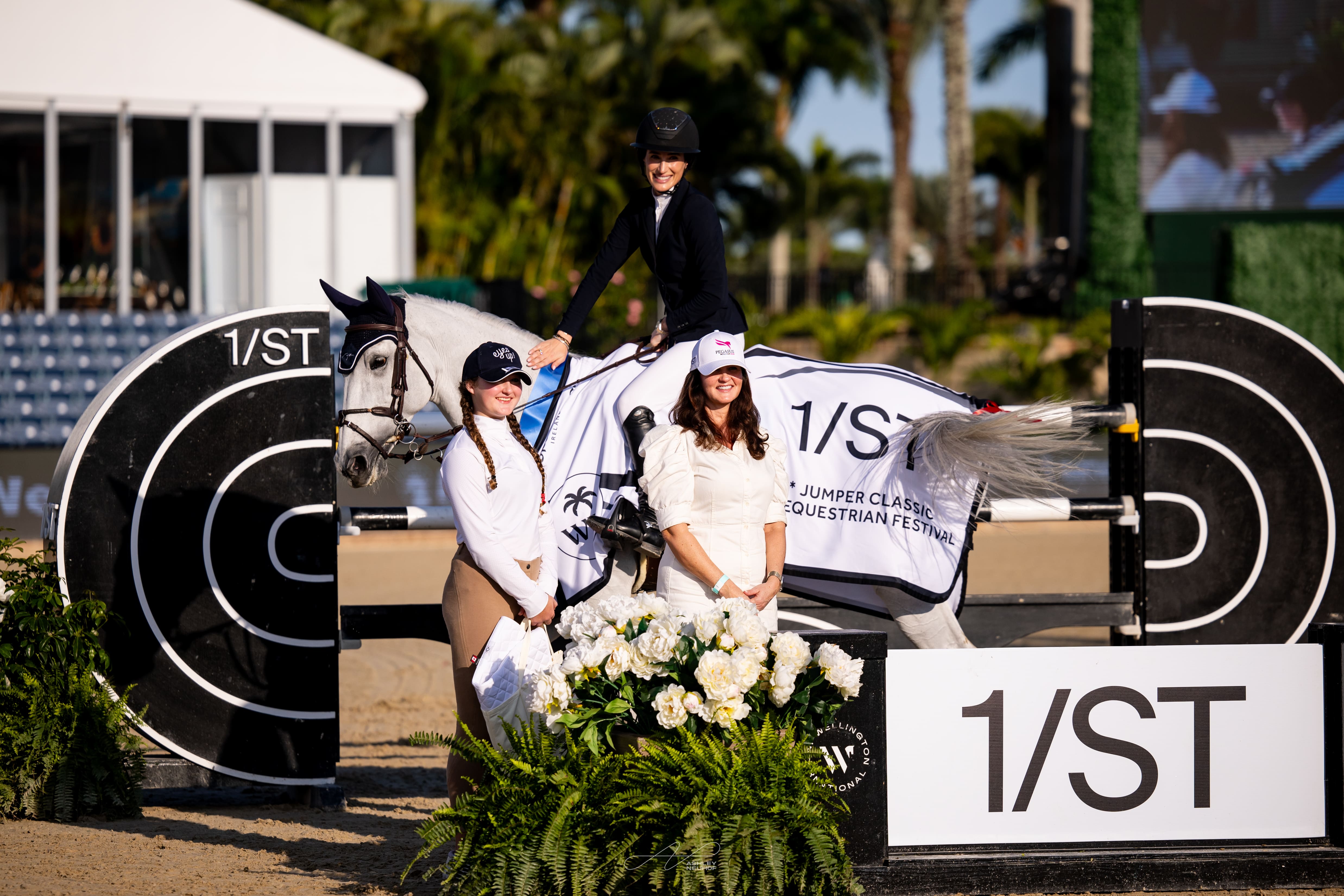 Jessica Springsteen & Naomi van het Keizershof are presented as winners of the $32,000 1/ST CSI2* Qualifier by Orlie Tonellato and Tiffani Steer, VP Communications, 1/ST & The Stronach Group. Photo © Ashley Neuhof