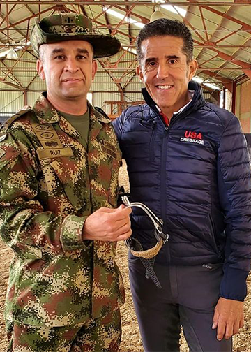 Head Master of Training for the Columbian, Cavalry, Parra passes the spurs to Coronel Carlos Fernando Ruiz