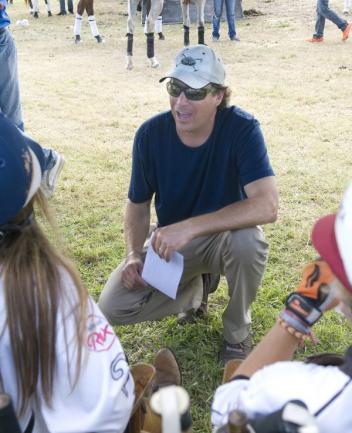 Grand Champions coach John Gobin talks strategy with his players before the game. Photo by Scott Fisher
