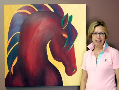 Michele Hundt, the owner of ShowChic dressage boutique in Wellington, Florida, is also the boutique&rsquo;s resident artist. Hundt, who paints in bold colors and abstract shapes, stands in front of her painting called &ldquo;Tijuana.&rdquo; 