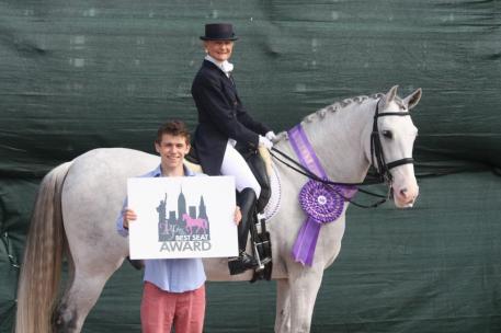 Janne Rumbough and Junior are presented with the 2kGrey Best Seat Award by Austen Stone