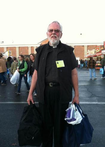 Father Mack in “Sherpa mode,” helping to cart home purchases and some of the wealth of informational literature on offer at these and kindred expositions.