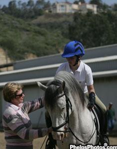 Para Dressage judge from the Netherlands, Hanneke Gerritsen, checks Sydney's reins.