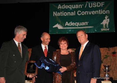 USDF president George Williams congratulates Steffen Peters and Jen and Bruce Hlavacek owners of USDF Intermediare Horse of the Year, Weltino's Magic (photo: phelpsphotos.com)