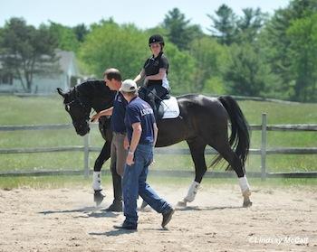 Coaches Kai Handt and Wes Dunham demonstrate working together with rider Sydney Collier and horse Wentworth Photo by Lindsay McCall