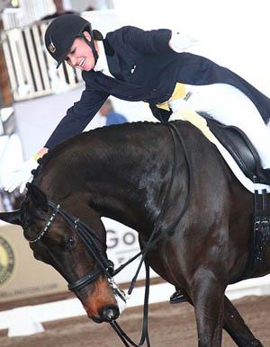 Adrienne Lyle and Wizard celebrate victory in the World Dressage Masters Grand Prix Special