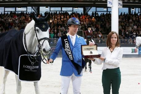 Elisa Gasparini, Brand Manager Longines Italy, presents Christian Ahlmann with his winner’s watch after the German rider won the thrilling third leg of the Longines FEI World Cup™ Jumping Western European League 2013/2014 at Verona, Italy today riding Aragon Z.  Photo: FEI/Stefano Secchi.