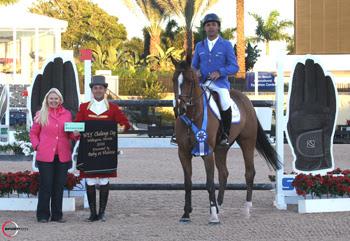 Alvaro ‘Doda’ Miranda, mounted on AD Uutje, is presented with a ,000 bonus from Jennifer Ward on behalf of SSG Gloves for wearing SSG ‘Digitals’ on his way to victory in the ,000 WEF Challenge Cup Round II at the 2014 FTI Consulting Winter Equestrian Festival in Wellington, FL. Photo by Sportfot