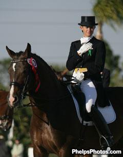 Elisabeth Austin and Olivier wear green ribbon pin during the Grand Prix Awards ceremony in support of Courtney Dye.