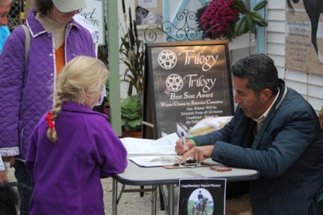 Dr. Cesar Parra signing autographs at the Trilogy both at Dressage at Devon.