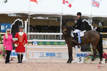  Chloe D. Reid claimed her second bonus of the year from SSG Gloves after winning the ,000 Junior Jumper Classic on February 9 riding Athena.  Presenting on behalf of SSG Gloves is Jennifer Ward with ringmaster Gustavo Murcia. Photo by Sportfot