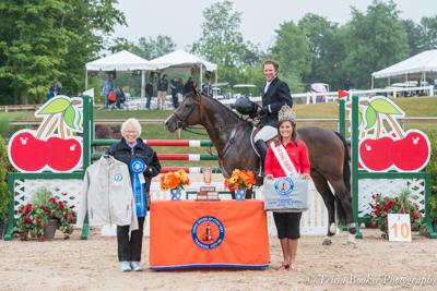 Ammeretto and David Beisel receive their awards from Karin Flint, left, and National Cherry Queen Sonya Sayler