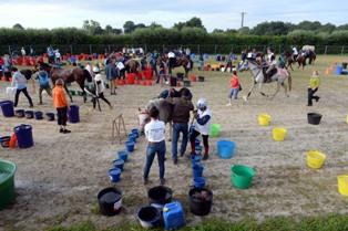 Buckets of water lined up for hores as they enter a rest stop.  Photo Credit: Philippe Millereau