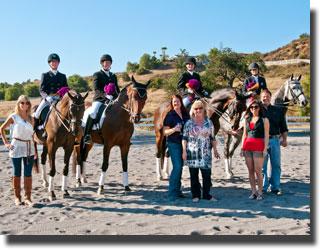 Riders pose with Nicole Bhathal, Kristin Young (Co-Chair, CDS San Juan Capistrano Chapter), and the Kearns Family.