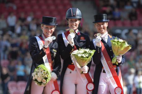 Britain’s Charlotte Dujardin and Valegro won the Grand Prix Special at the Blue Hors FEI European Dressage Championships 2013 in Herning, Denmark today. Pictured on the podium (L to R): silver medallist Helen Langehanenberg (GER), gold medallist Charlotte Dujardin (GBR) and bronze medallist Adelinde Cornelissen (NED). (Photo: FEI/Kit Houghton)