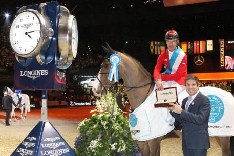 Juan Carlos Capelli, Head of International Marketing for Longines, presents Pius Schwizer with a Longines watch after the Swiss rider, riding Toulago, won the eighth leg of the Longines FEI World Cup&trade; Jumping Western European League 2013/2014 series at Zurich, Switzerland today. Photo: FEI/Valeria Streun.
