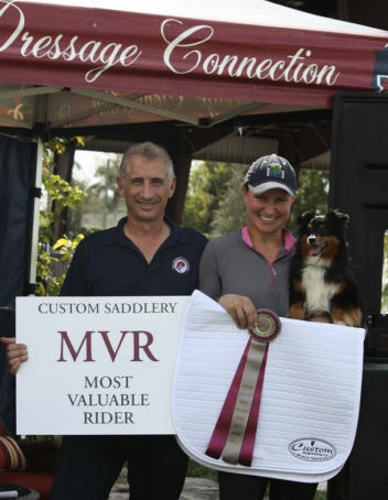 Charles Tota of The Dressage Connection presents Adrienne Lyle with the Custom Saddlery Most Valuable Rider Award.