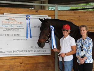Cathy Morelli (left) and her Dutch Warmblood, BeSe, won the  Grand Prix at the Gold Coast Dressage Association’s Grand Finale I show held at the Jim Brandon Equestrian Center. The class was sponsored by The Sanctuary Equine Sports Therapy &amp; Rehabilitation Center, a world-class facility in Ocala dedicated to helping horses that compete in physically demanding sports. Morelli is joined by show manager Noreen O’Sullivan.