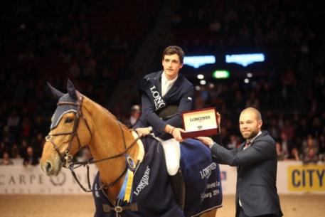 Kalle Sternberg, Brand Manager for Longines, Sweden, presents a Longines watch to Nicola Philippaerts after the young Belgian rider won the last qualifying round of the Longines FEI World Cup™ Jumping 2013/2014 Western European League at Gothenburg, Sweden today.  Photo: FEI/Roland Thunholm.