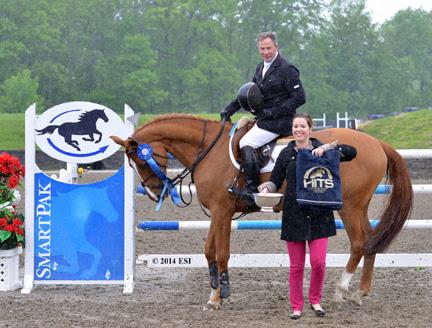 Asia Manning of HITS presented winner’s honors, including a Horze Equestrian cooler, to Peter Leone and My Pleasure after their win in the ,000 SmartPak Grand Prix, presented by Zoetis. ©ESI Photography