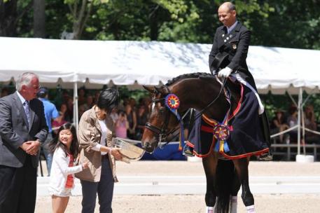 Steffen Peters, Akiko Yamazaki (with daughter Miki) and Legolas celebrate the USEF Dressage National Championship (Photo: Tigger Montague)