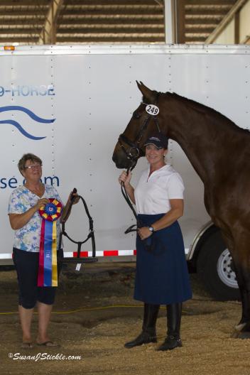 Christy Raisbeck and Fernando won The Horse of Course High Score Award at the Houston Dressage Society Spring Classic I show. Beth Haist presents the award. (Photo: SusanJStickle.com)