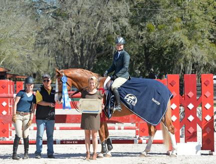 Tracy Fenney and MTM Timon are presented with winner’s awards, including a Horze Equestrian cooler, after the ,000 SmartPak Grand Prix, presented by Zoetis, at HITS Ocala. ©ESI Photography