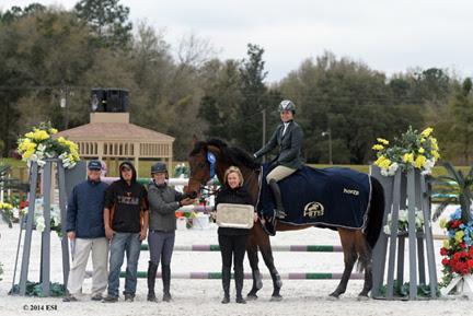 Tracy Fenney and MTM Centano are presented with winner’s prizes, including a Horse Equestrian cooler, after the ,000 SmartPak Grand Prix, presented by Zoetis, at HITS Ocala. ©ESI Photography