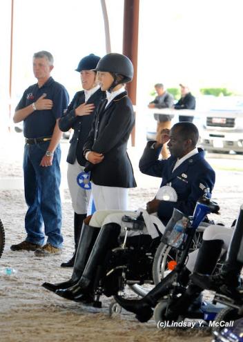 Left To Right- Kai Handt, Mary Jordan, Elizabeth Traband, and Derrick Perkins U.S. Air Force Wounded Veteran salute the U .S. flag during the National Anthem. 