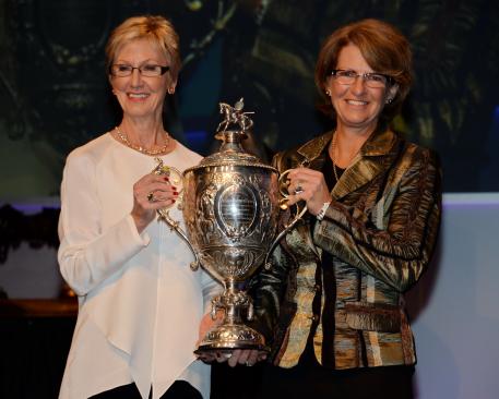 USEF President Christine Tauber presents the U.S. Equestrian Federation’s 2013 Equestrian of the Year trophy to showjumper star Beezie Madden. Photo: Diana DeRosa