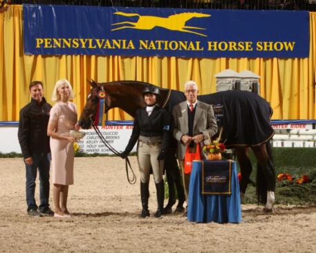 Victoria Colvin and OVATION receive their award from Norman White, Chairman of the Board of the Pennsylvania National Horse Show with trainer Scott Stewart and owner Dr. Betsee Parker