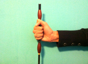 The whip should be held in place by a combination of your palm and lower fingers, primarily the pinky.