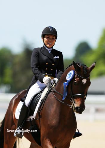 Taylor Yamamoto and Domino take a victory round after winning the FEI Young Rider Team Test. Photo: Mary Phelps