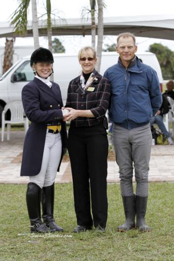 Alex Dvorak is congratulated by IHS Palm Beach Dressage Derby show manager Noreen O'Sullivan and Dad Tom Dvorak for winning the Courtney King Dye Helmet Awareness Award. Sponsored by Hampton Green Farm, Renee Isler and GPA Helmet, the highest scoring rider wearing a helmet in the CDI Young Riders.