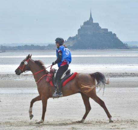 Jessica Manness and Greater Glide loping down the beach across from Bay of Mont Saint Michel. Photo by Diana DeRosa