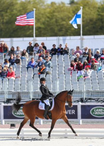 Grade II rider Rebecca Hart is all smiles aboard Schroeter's Romani in their individual test today. Photo copyright SusanJStickle.com