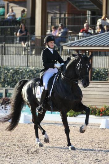 Ashley Holzer and Dressed In Black on their way to winning the FEI Grand Prix Freestyle CDI 3* presented by Adequan® at the first inaugural FEI CDI 3*  hosted at TIEC.