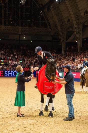 Carl Hester (GBR) and Nip Tuck receive the Reem Acra Trophy from the Princess Royal