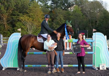 Gavin Moylan, pictured with his family and HITS Representative Asia Manning, winning the $30,000 HITS Grand Prix. 