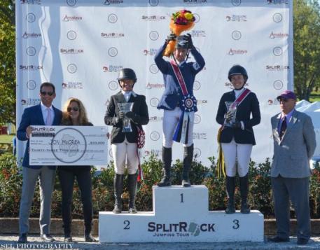 Jonathan McCrea stands atop the podium after the 00,000 CSI3* Grand Prix win