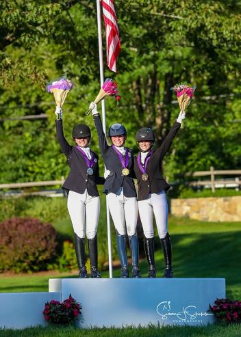 USDF North American Junior Dressage Individual Championship medalists from left to right: Bianca Schmidt (silver), Caroline Garren (gold), and Chase Robertson (bronze). (SusanJStickle.com)