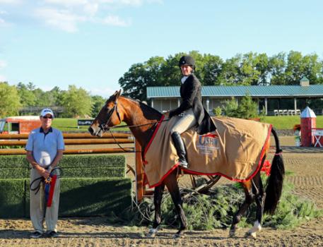 Kelley Farmer winning the 00,000 USHJA International Hunter Derby pictured with trainer Larry Glefke. 