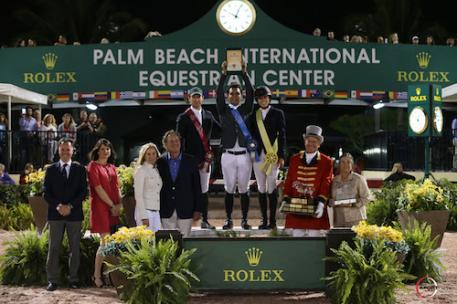 McLain Ward, Sergio Alvarez Moya, and Karen Polle on the podium with (L to R): Joël Aeschlimann, Head of Sponsorship, Rolex; Anne Pradal-Carrega, Communication & Image - Sponsorship, Rolex; Katherine and Mark Bellissimo of Equestrian Sport Productions; ringmaster Steve Rector; and Marsha Dammerman of Wellington Equestrian Partners presenting The Dennis Dammerman Perpetual Trophy.