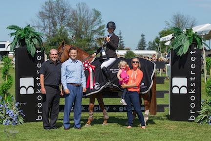 The Honorable Pierre Poilievre, National Capital Commission (NCC) Minister and Minister of Employment and Social Development, Mark Nisbett of Brookstreet Hotel, and Karen Sparks of Wesley Clover Parks and her daughter Summer, present Elizabeth Bates and Wildfire as the winners of the $35,000 Brookstreet Grand Prix at the Ottawa International. (Photo: Ben Radvanyi Photography)