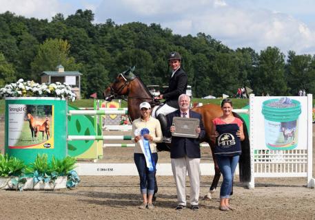 Tony Hitchcock and Lindsay Yandon of HITS present Kevin Babington and Mark Q with winner's awards, including a Horze Equestrian cooler, after the 00,000 Strongid© C 2X™ Grand Prix presented by Zoetis at HITS Saugerties. ©ESI Photography