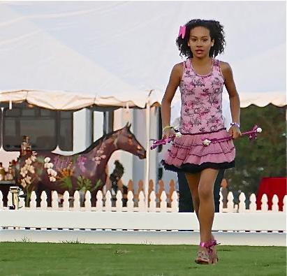 Baton twirler Kayden Muller led the procession to the piping tunes of Shirley Temple Black, the pink motif customary at the 2015 Challenge of the Americas.