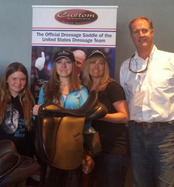anell and Julie Scherbarth win a Custom Saddlery saddle at the 2015 Reem Acra FEI World Cup Dressage and Longines FEI World Cup Jumping Finals. From left to right: Ava Wallace of Custom Saddlery, Janell Scherbarth, Julie Scherbarth, and Scott Carling of the United States Equestrian Federation