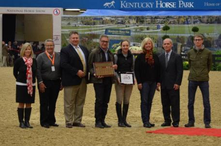 USHJA's Maria Holt, Zone 5 Chairpersons Diane Carney and Patrick Boyle, Greg Darst, Maddy Darst, Patti Rogers, USHJA President Bill Maroney and John Darst for the presentation of the Posthumous Award to the late Mindy Darst. Photo by Chicago Equestrian.