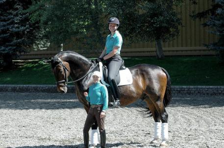 “Premier Equestrians” Debbie McDonald (front) and Adrienne Lyle, riding Wizard, will be available to meet and take “seflies” with at the Premier Equestrian booth at the 2015 Reem Acra FEI World Cup Dressage